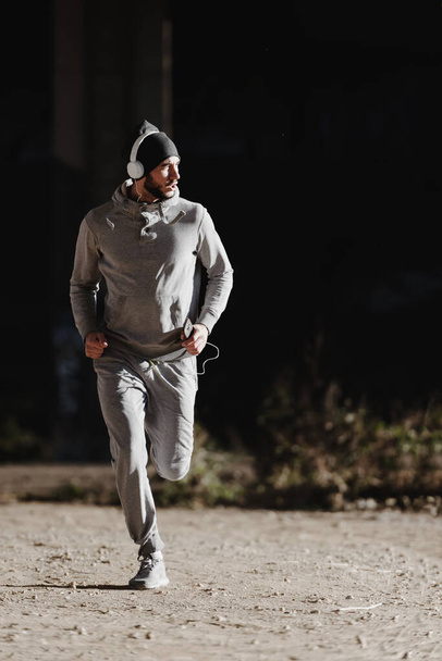 Man urban runner having intensive training outdoors in the morning - Fotoğraf, Görsel