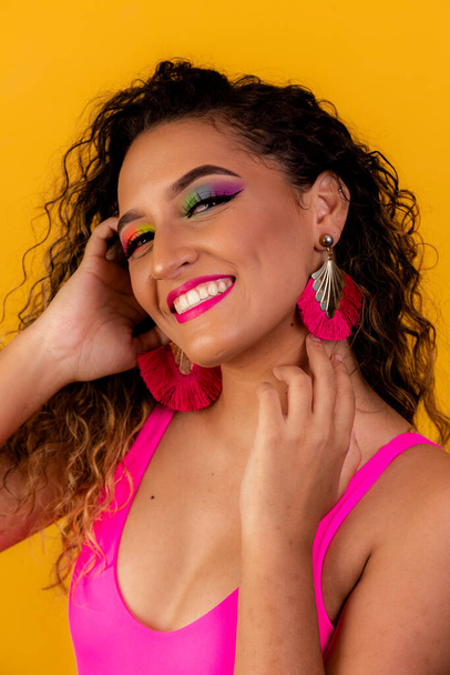 Beauty portrait of african american woman with afro hairstyle and glamour makeup. Brazilian woman. Mixed race. Curly hair. Hair style. Yellow background. Afro woman smiling at the camera - Φωτογραφία, εικόνα