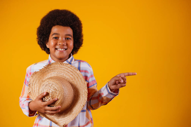 Portrait of a little boy afro wearing typical clothes for the Festa Junina - Фото, изображение