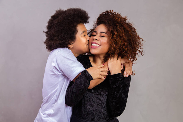 son kissing his mother's cheek. mother's day concept - Foto, afbeelding