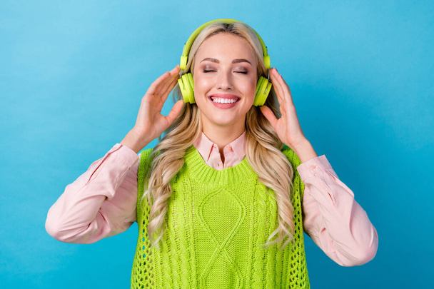 Photo of young business lady closed eyes listen headphones relax chill new spotify lana del rey soundtrack isolated on blue background. - Photo, Image