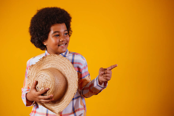 Portrait of a little boy afro wearing typical clothes for the Festa Junina - Fotografie, Obrázek