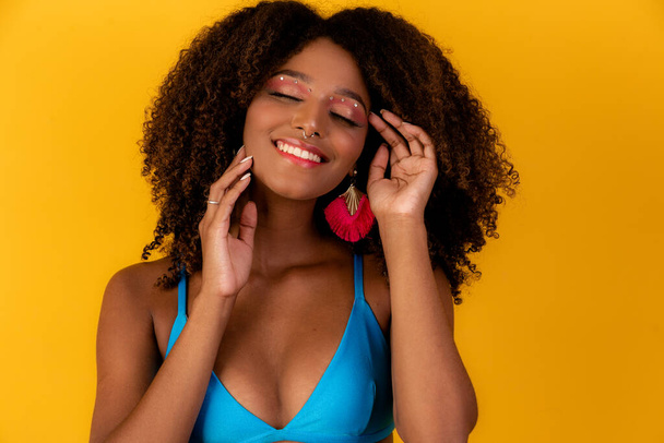 Beautiful afro girl with curly hair and bikini smile at the camera - Photo, image