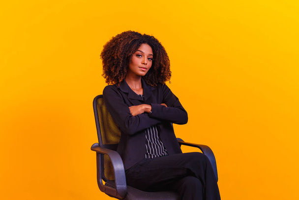 Successful black woman, business woman. afro woman in pantsuit with arms crossed - 写真・画像