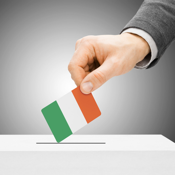 Voting concept - Male inserting flag into ballot box - Ireland - Valokuva, kuva