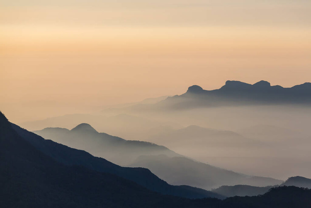 mountain silhouette at sunrise in spring season - Foto, imagen