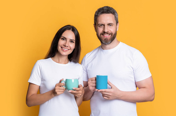 Couple of guy and girl drinking morning coffee. Happy couple enjoying coffee in morning studio. Morning drink. Good morning. - Фото, зображення