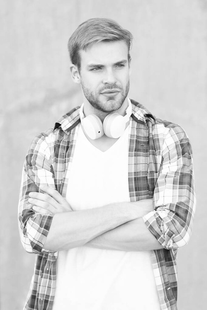 casual man music lifestyle concept. man music lifestyle wearing checkered shirt. photo of man music lifestyle with headphones. man music lifestyle outdoor. - Foto, immagini