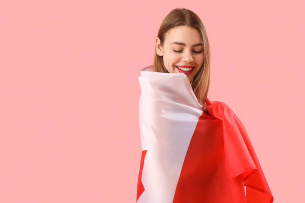 Young woman with flag of Canada on pink background - Фото, изображение