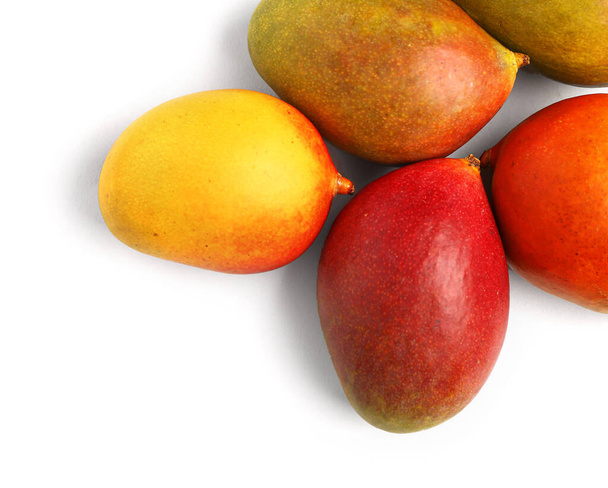 Fresh ripe mangoes on light background - Photo, Image