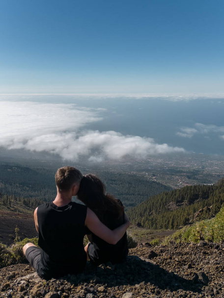 man and woman in love, travelers family on mountains peak hugging - Фото, изображение