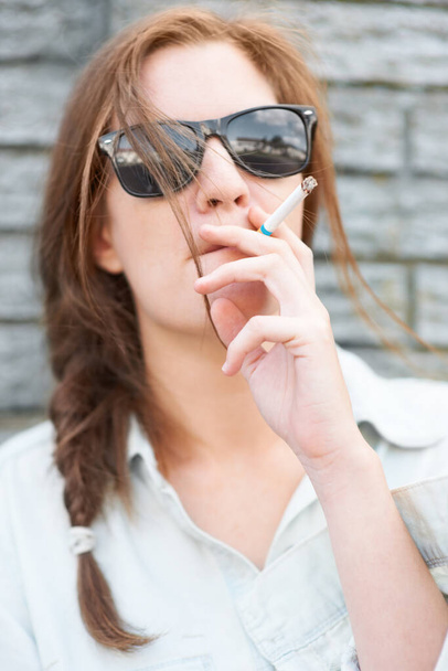 Mind if I smoke. Trendy young hipster girl smoking a cigarette - Foto, afbeelding