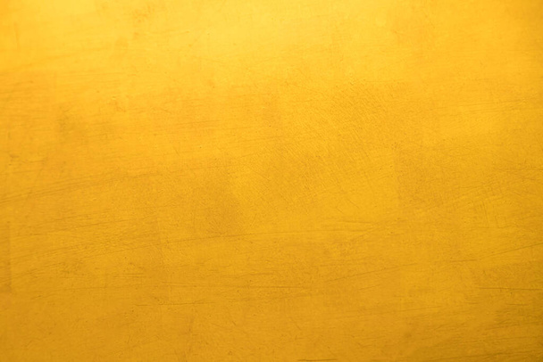 Gold paint on cement wall texture background - Foto, imagen