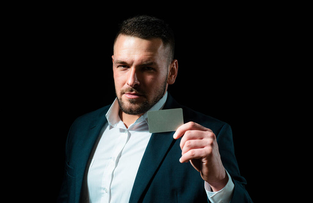 Businessman entrepreneur in suit holds credit card. Cashcard, creditcard, bank concept. Copy space for advertise. Businessman with a creditcard - Zdjęcie, obraz