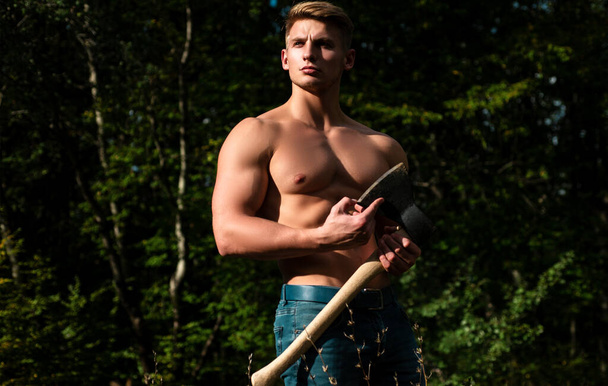 Lumberjack muscled young man. Shirtless athletic naked guy, nature outside - 写真・画像