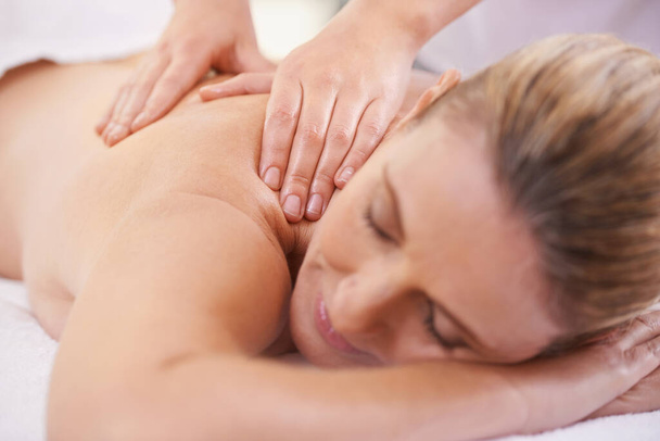 She needed this. a woman in a day spa relaxing on a massage table - Zdjęcie, obraz