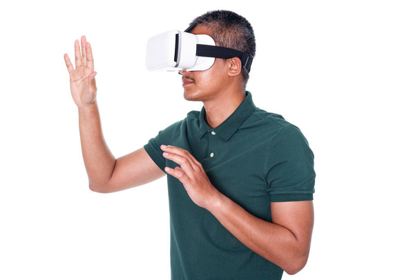 Man wearing virtual reality headset isolated on white background.  trying to touch something with hand - Foto, Imagen