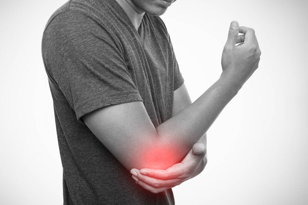 Man pain in the elbow isolated on gray background - Photo, Image