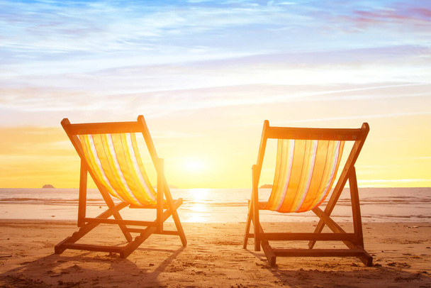 beach tourism, holiday background with couple of deck chairs at sunset - Фото, зображення