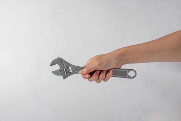 Hand and a wrench isolated on white background. - Fotó, kép