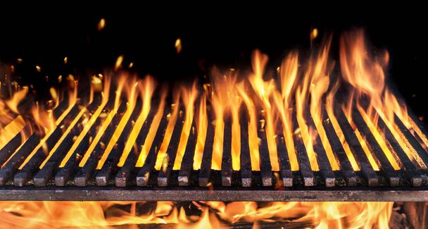 Barbecue grill with fire flames closeup on dark background. - Zdjęcie, obraz