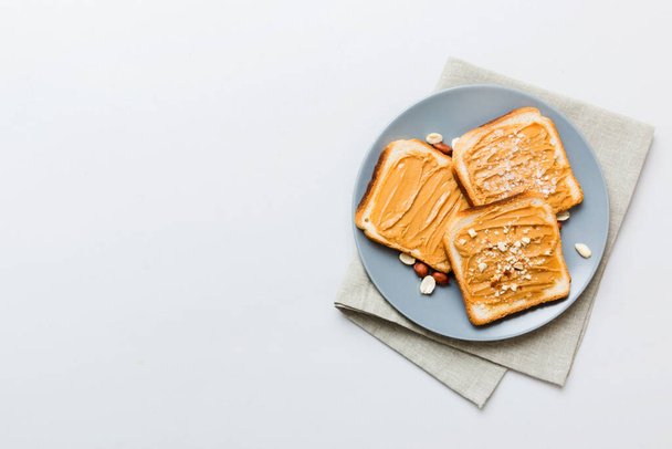 Peanut butter sandwiches or toasts on light table background.Breakfast. Vegetarian food. American cuisine top view vith copy space. - Photo, Image