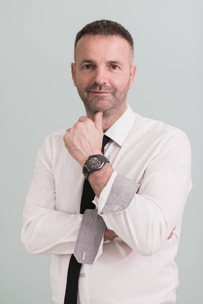 casual older with beard businessman wearing formal business clothes smiling at camera with crossed hands isolated over gray background. High quality photo - Foto, Imagem