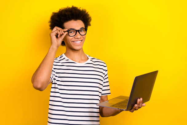 Photo of smart think decide man wear striped trendy t-shirt hold netbook remote education part time job isolated on yellow background. - Φωτογραφία, εικόνα