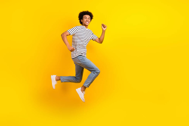 Full length size photo of running fast speed energetic guy hurry up advertisement casual clothes sale isolated on yellow color background. - Fotó, kép