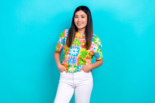 Photo of pretty shiny woman dressed flower print t-shirt smiling hands arms pockets isolated blue color background. - Фото, зображення