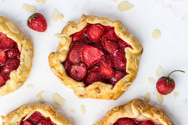 Juicy delicious postcard with strawberry miniscutters. Top view of berry portion pies - Fotografie, Obrázek