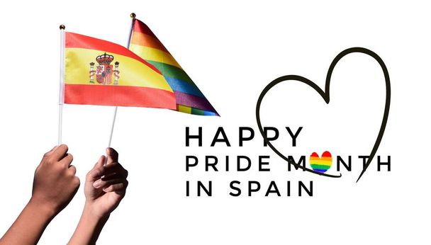 Spain flag and rainbow flag holding in hand with texts 'Happy pride month in Spain', concept for celebrating of LGBT people in Spain in pride month, June. - Photo, Image