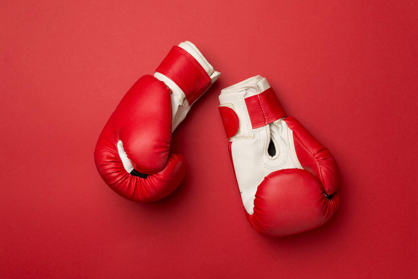 Red boxing gloves on color background, top view. - Fotografie, Obrázek