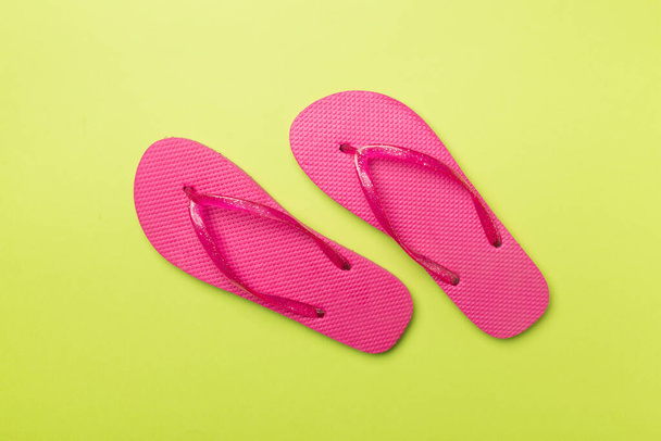 Bright flip flops on color background, top view - Foto, afbeelding
