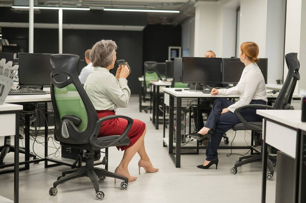 Четыре офисных работника разговаривают во время перерыва - Фото, изображение