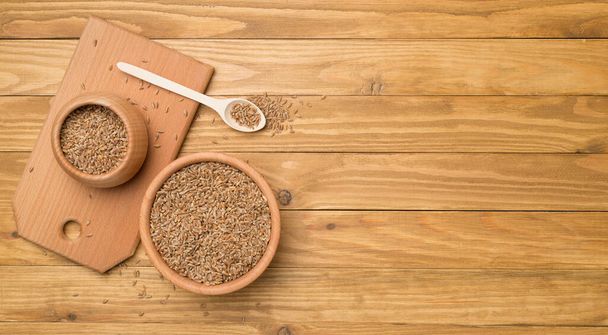 Bowls with wholegrain spelt farro on wooden background. Top view. - 写真・画像
