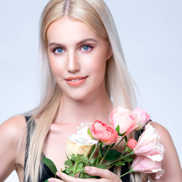 Closeup young personable woman with natural makeup and healthy soft skin holding rose for beauty care advertising in isolated background. Beautiful pretty model girl with flower concept. - Foto, immagini