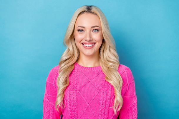 Photo of adorable pretty young lady wear pink sweater smiling showing white teeth isolated blue color background. - Фото, зображення