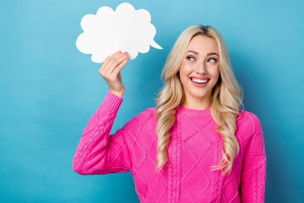 Portrait of positive sincere woman with wavy hairdo wear pink pullover hold mind cloud look empty space isolated on blue color background. - Foto, Bild