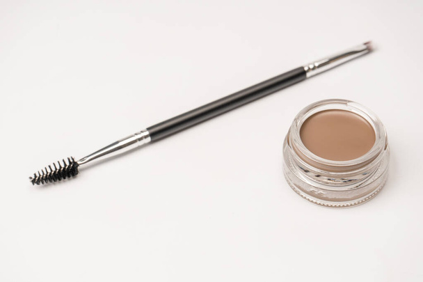 A brow pomade in blonde shade with brush isolated on a white background. Make up.  - 写真・画像