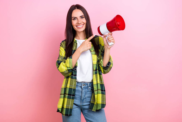 Photo of funky cool lady wear checkered jacket pointing finger bullhorn empty space isolated pink color background. - Fotó, kép