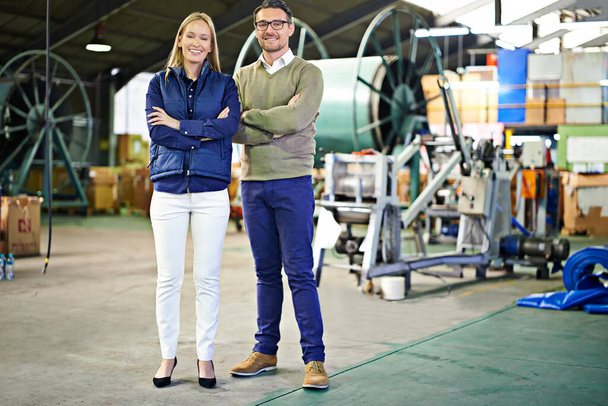 Taking care of all your export needs. a two coworkers managing a warehouse - Foto, afbeelding