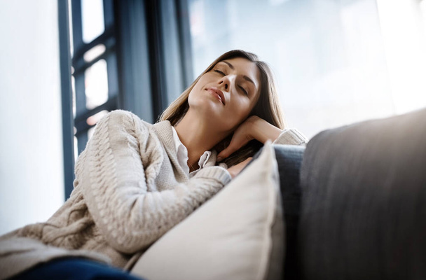 Relax, sleeping woman and living room couch at home with a nap and feeling calm. Sofa, house and lounge of a young female person in a apartment with rest and eyes closed dreaming from day off. - Zdjęcie, obraz