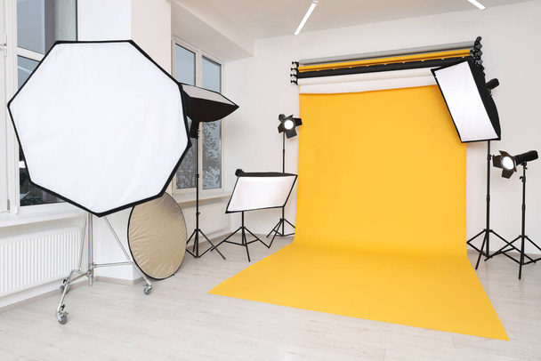 Interior of modern photo studio with professional lighting equipment - Фото, зображення