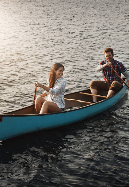 Adventures together is always better. a young couple rowing a boat out on the lake - Photo, Image