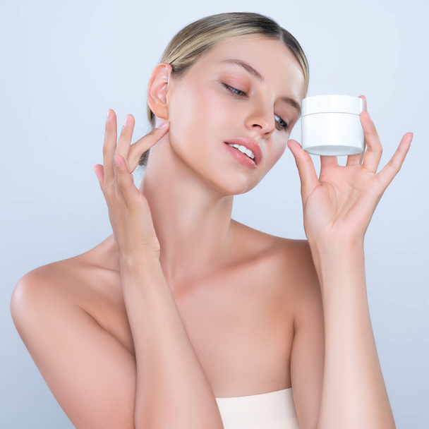 Alluring beautiful perfect cosmetic skin woman portrait hold mockup jar cream or moisturizer for skincare treatment, anti-aging product in isolated background. Natural healthy skin model concept. - Photo, image