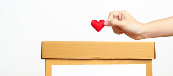 Organ Donation, Charity, Volunteer, Giving and blood Concept. Hand holding red heart into donate box for support poor, homeless, CSR social responsibility, world heart and  mental health day - Φωτογραφία, εικόνα