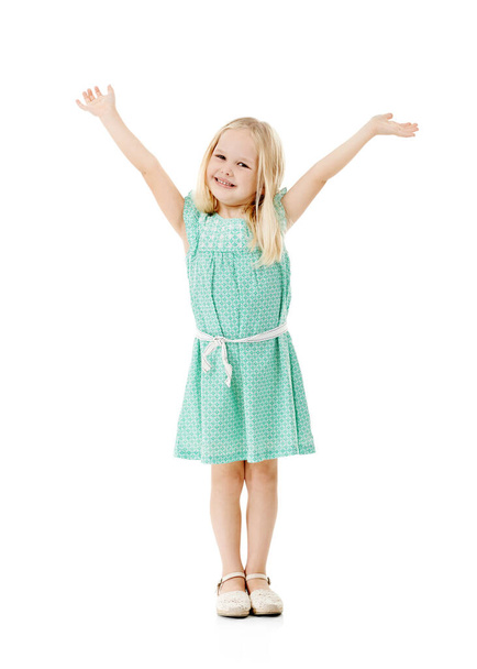 Im here. Studio shot of a cute little girl extending her arms in happiness against a white background - Foto, Imagem