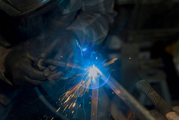 Protective mask heavy industry worker with argon welds steel in factorie and steel mill - 写真・画像