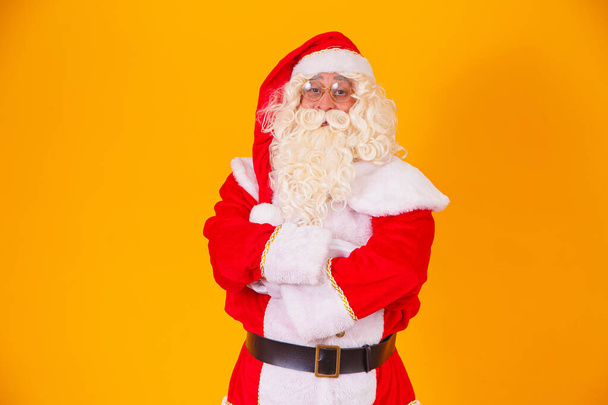 Santa Claus with crossed arms on yellow background. - Foto, Imagem